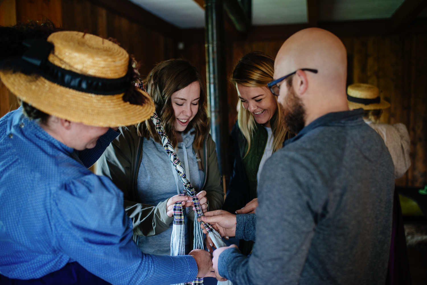 Visitors try finger weaving in the historic Clerk's Quarters